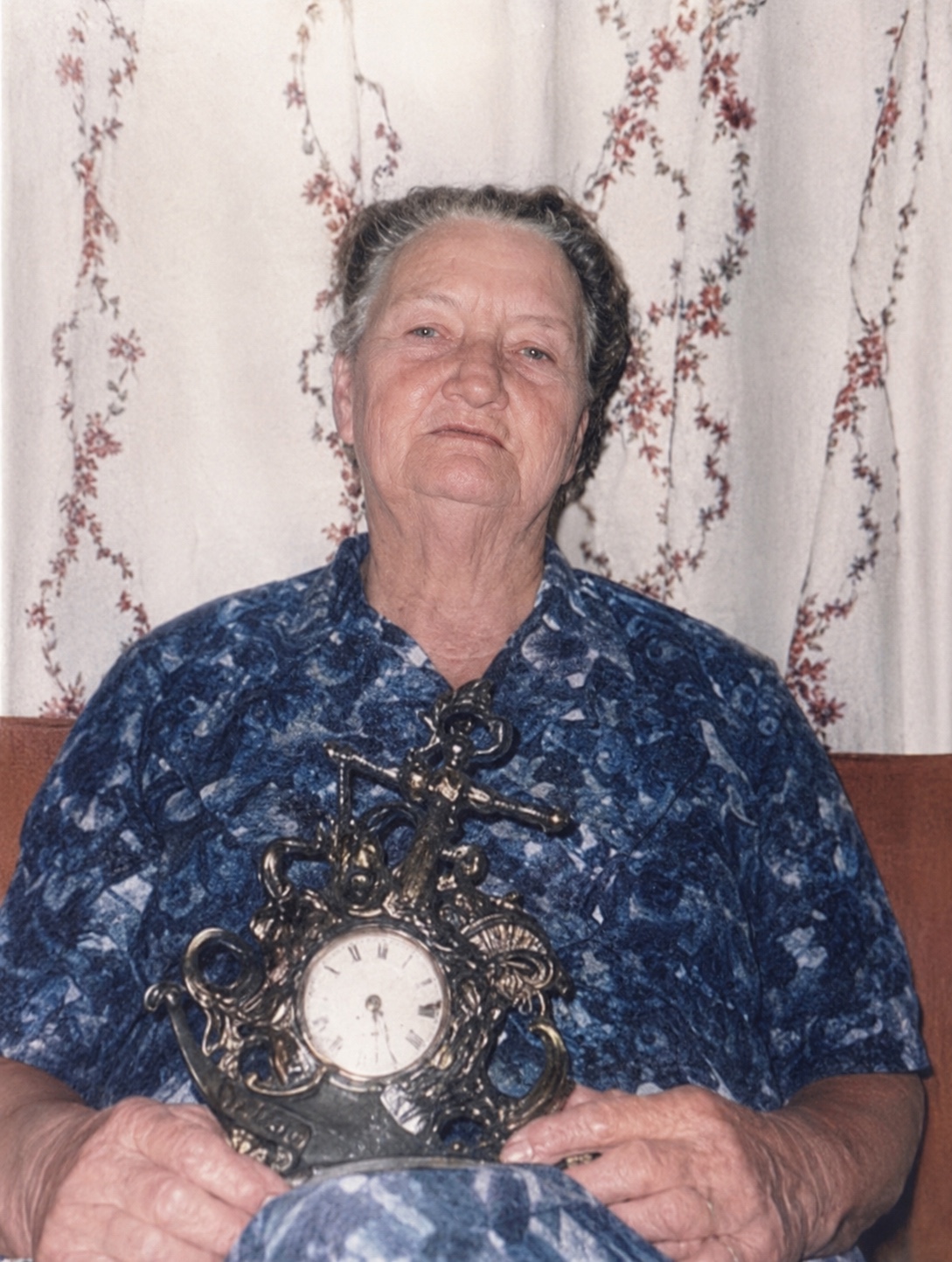 High-integrity restored photograph of Della Mae Ferguson holding the family clock