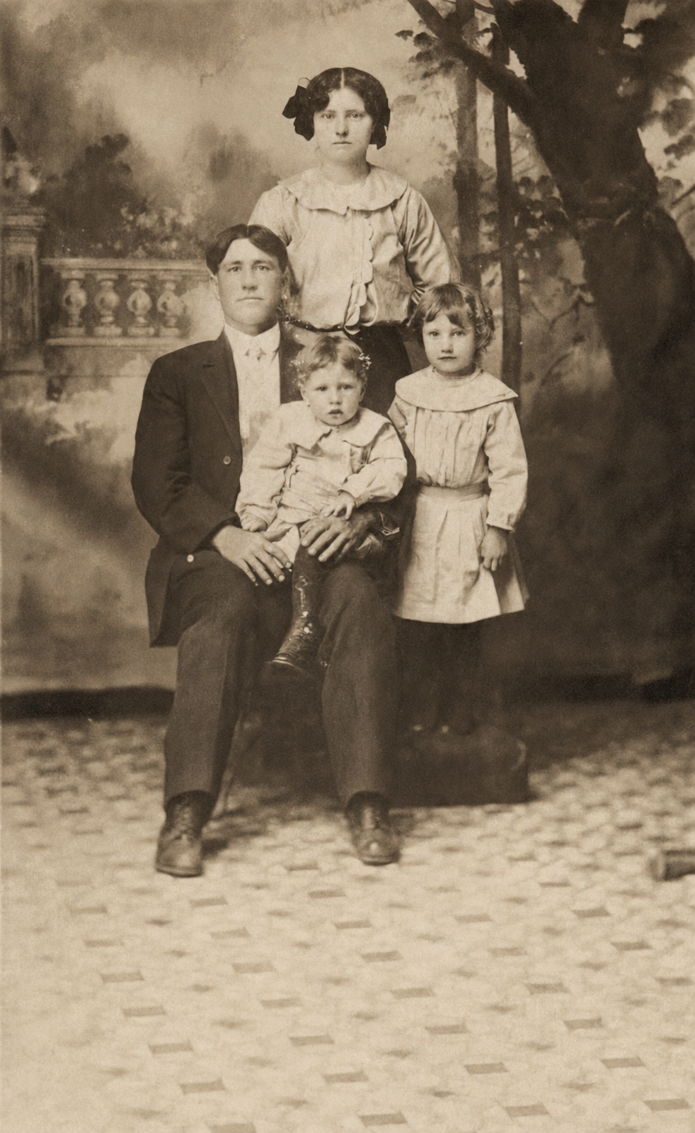 Restored family portrait of Edd Hollingsworth and Della Mae Ferguson with Edgar and Minnie