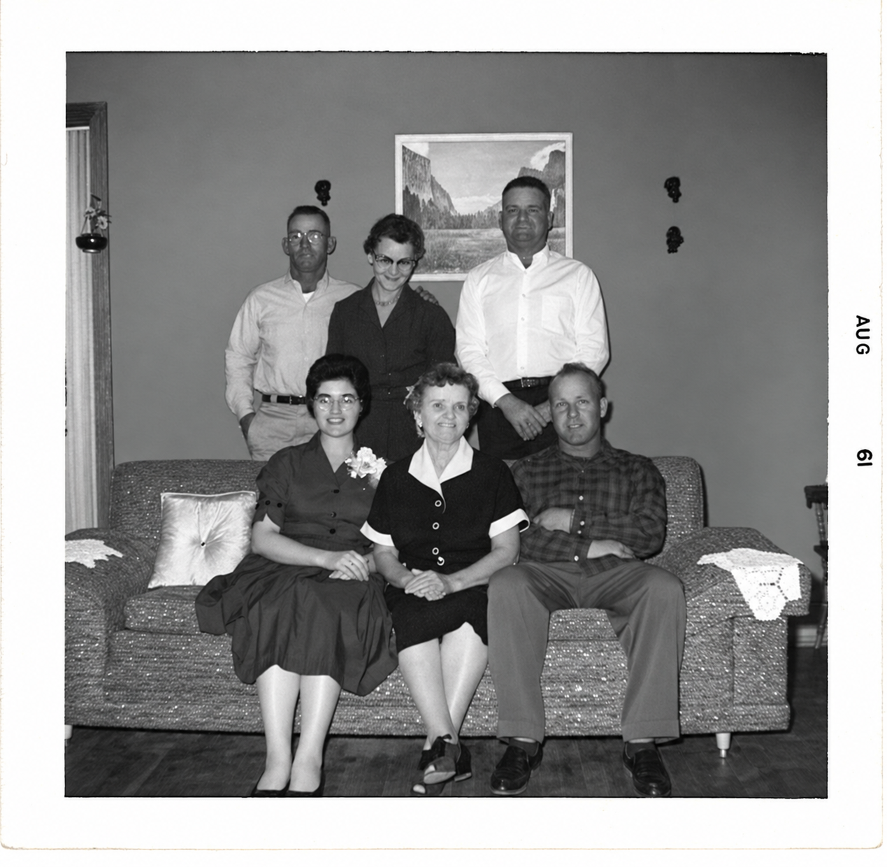 Six members of the Perry family posed together in a living room in August 1961.