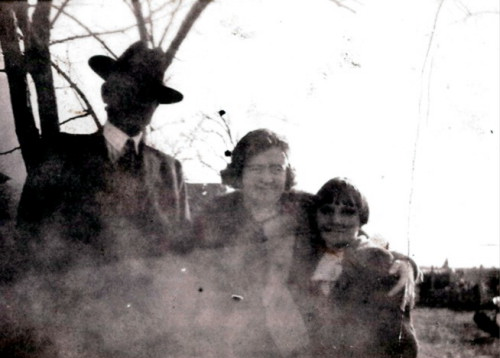 Small damaged outdoor group photograph with three people, preserved in Tennie’s family album