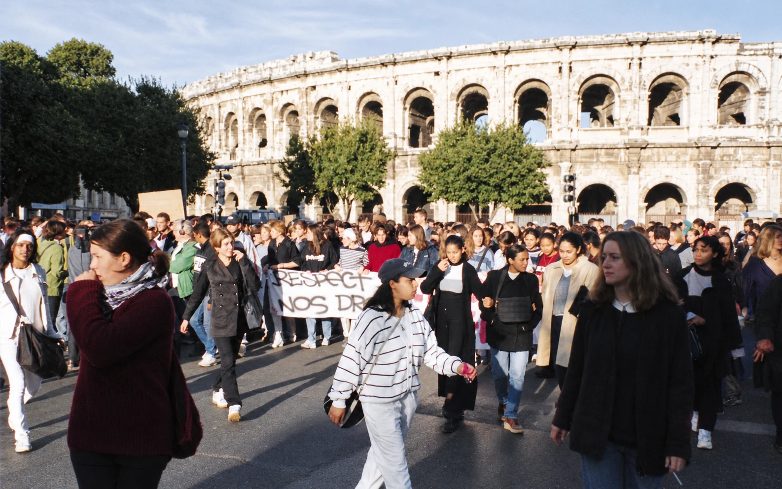 Students carrying banners as they march past the Roman arena in Nîmes.