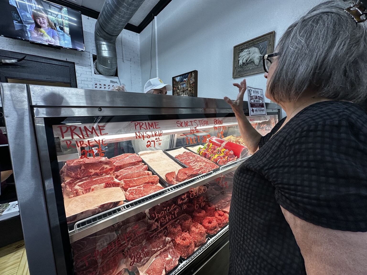 Gia Hollingsworth ordering at the butcher counter