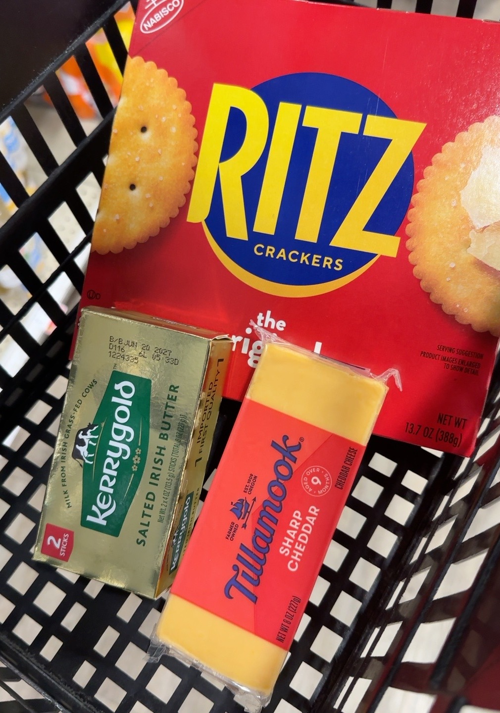 Ritz crackers, Tillamook sharp cheddar and Irish butter in a grocery cart