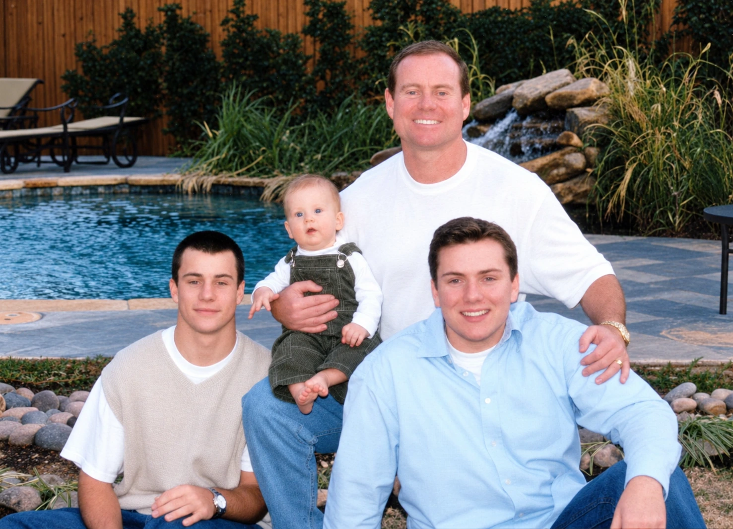Colby at left, baby Brock, Perry behind, and Clayton in front beside a pool