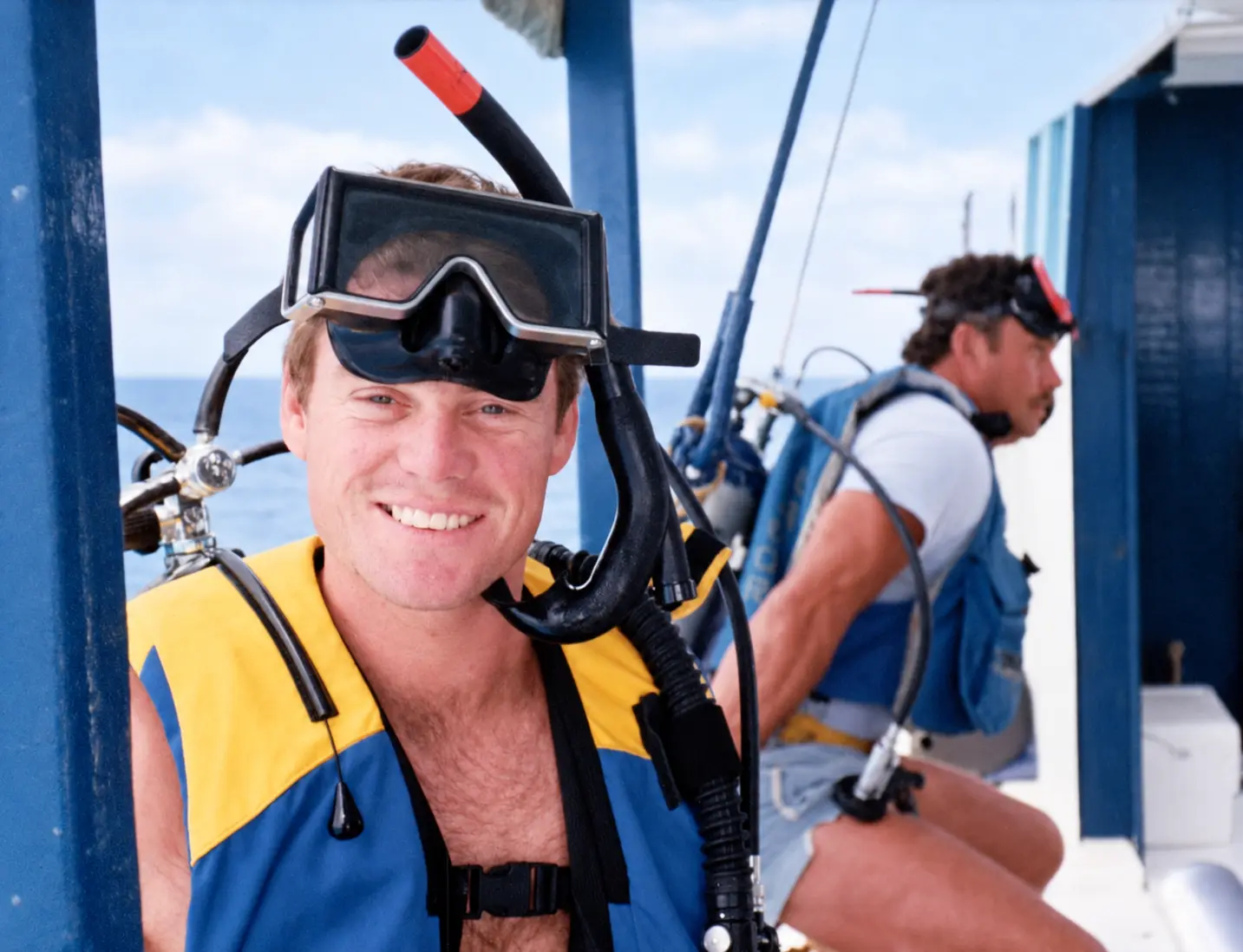 Perry Wayne Hollingsworth smiling in scuba gear, with another diver in the background